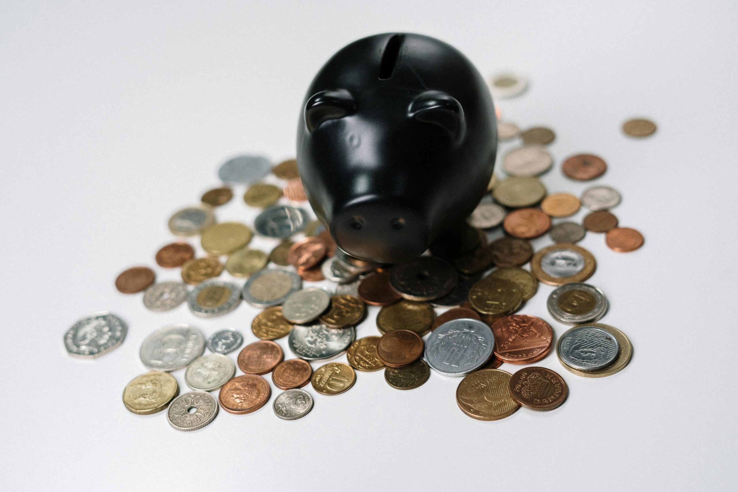 black piggy bank and coins